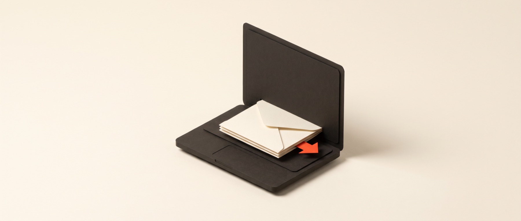 A papercraft laptop with a folded paper form sliding into the screen